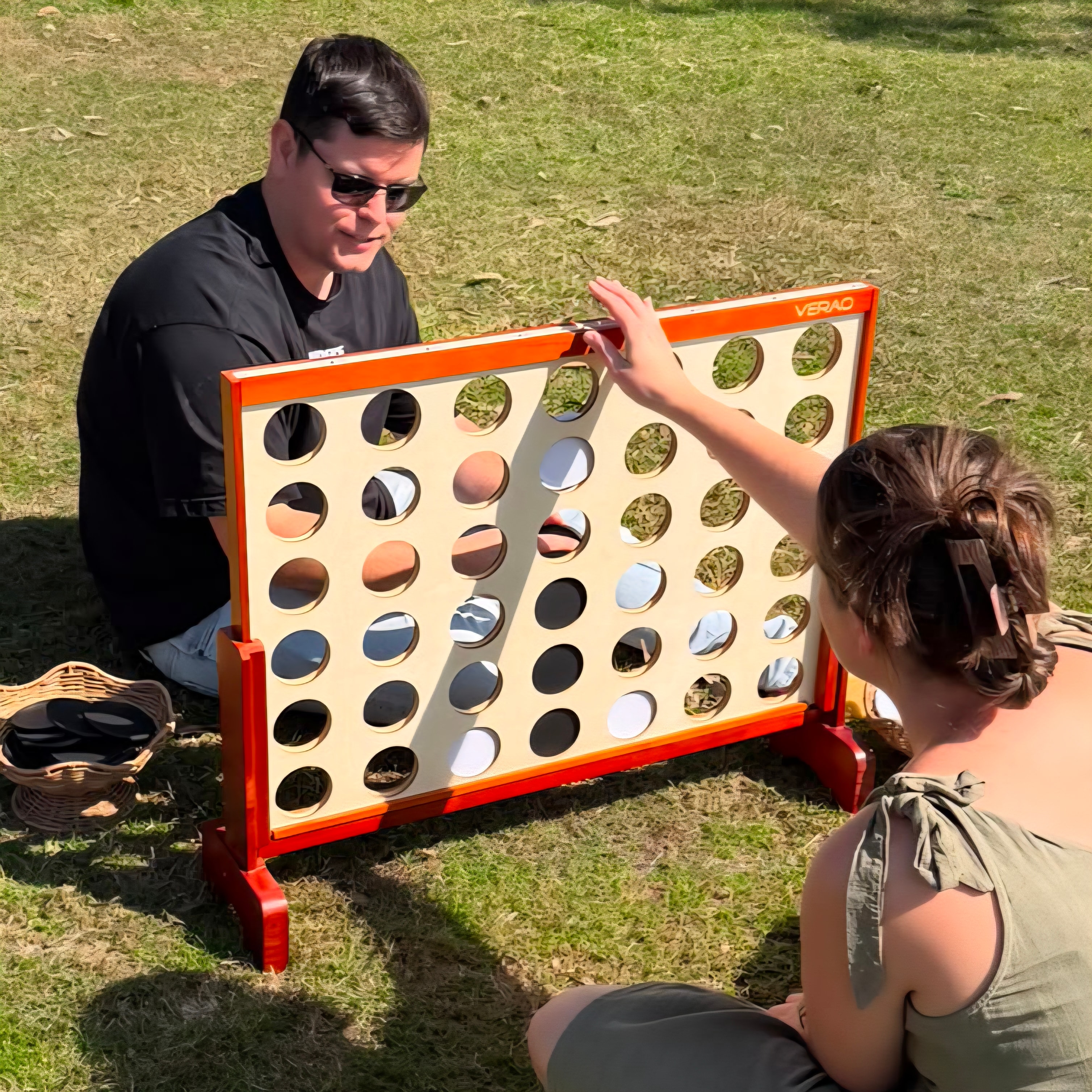 Guests playing giant four in a row at a Sunny Luxe event